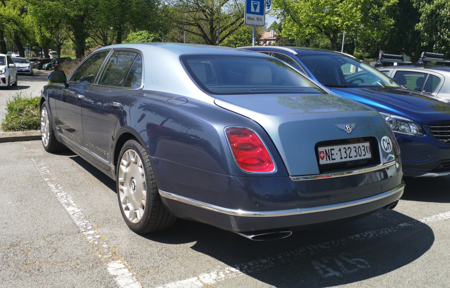 Luxury sedan rear view with distinctive taillights and chrome accents