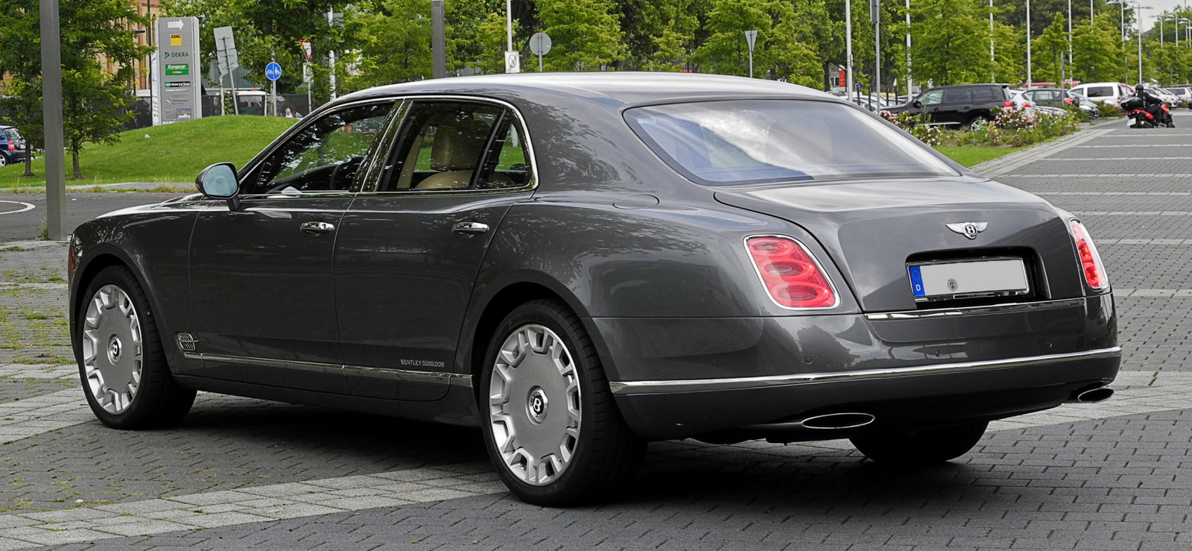 Rear and side view luxury sedan with distinctive taillights and silver alloy wheels.