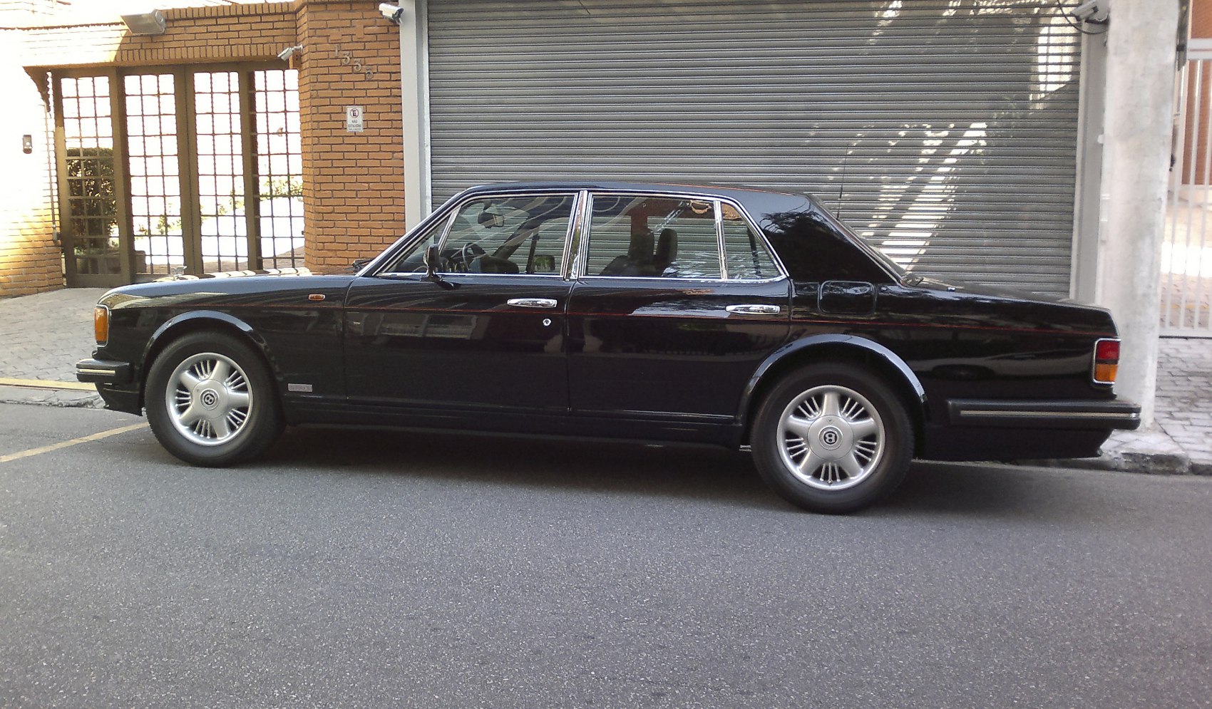 Side profile of a classic luxury sedan with chrome trim and premium wheels