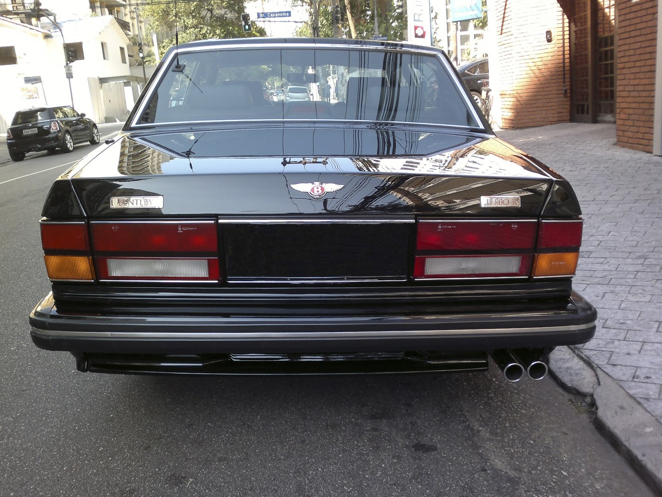 Rear view with taillights, Bentley emblem, and twin exhaust pipes