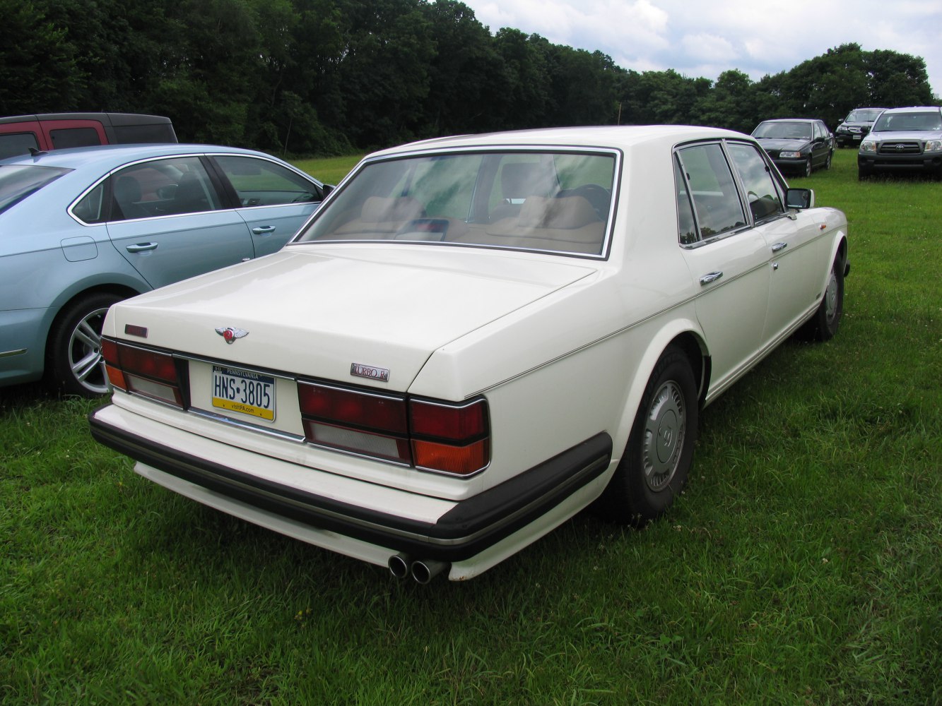 Luxury sedan rear view with twin exhaust and classic tail lights
