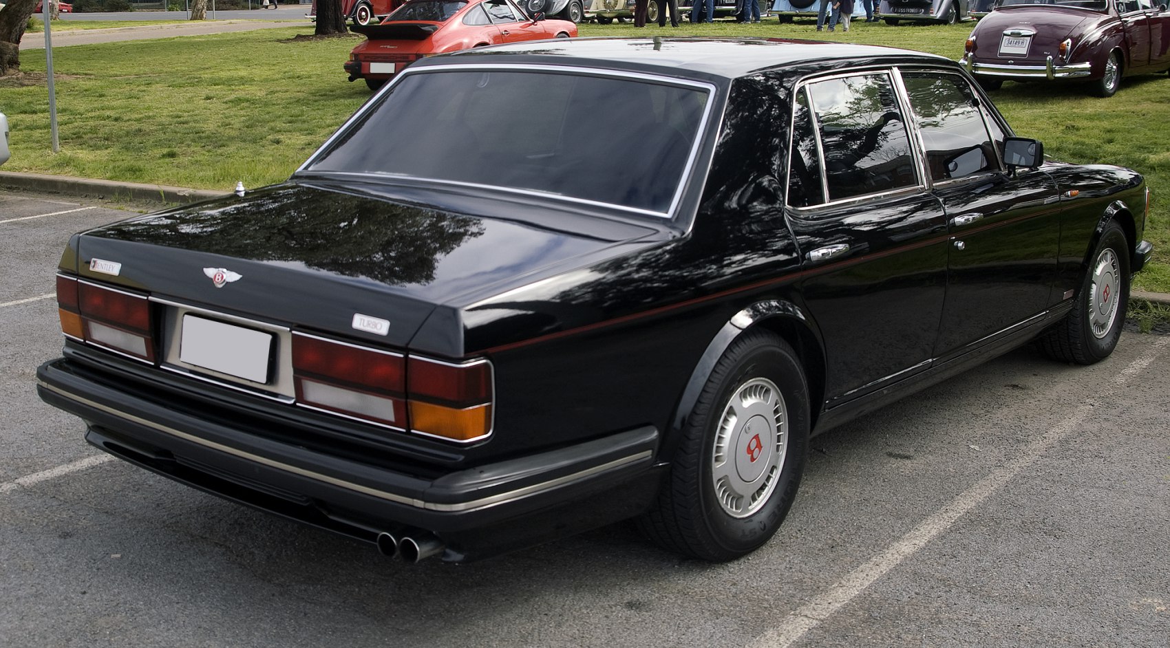 Rear view of a classic luxury sedan with distinctive tail lights and dual exhaust pipes