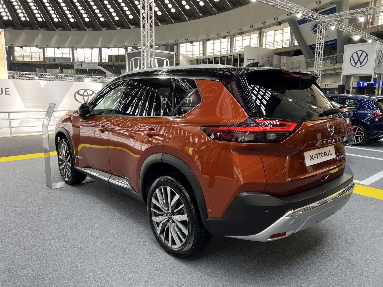 Rearn-side view of modern SUV with sleek taillights and alloy wheels