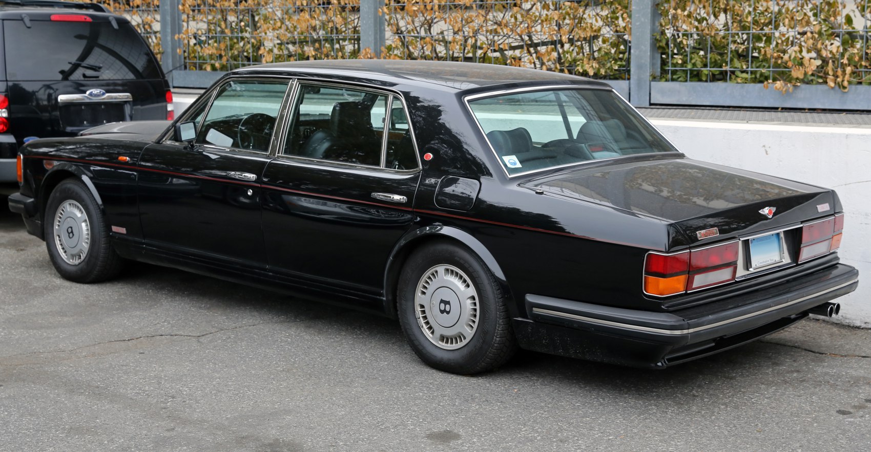 Rear view of a luxury sedan with chrome trim and distinctive wheels