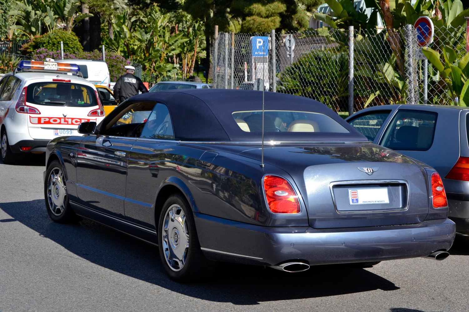 Rear view of a luxury convertible with soft top and distinctive taillights