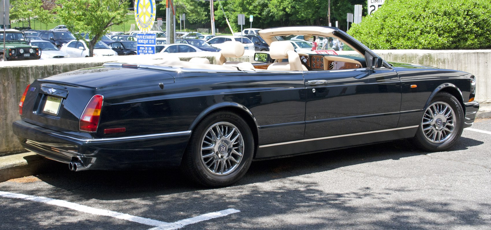 Luxury convertible with classic alloy wheels and beige leather interior