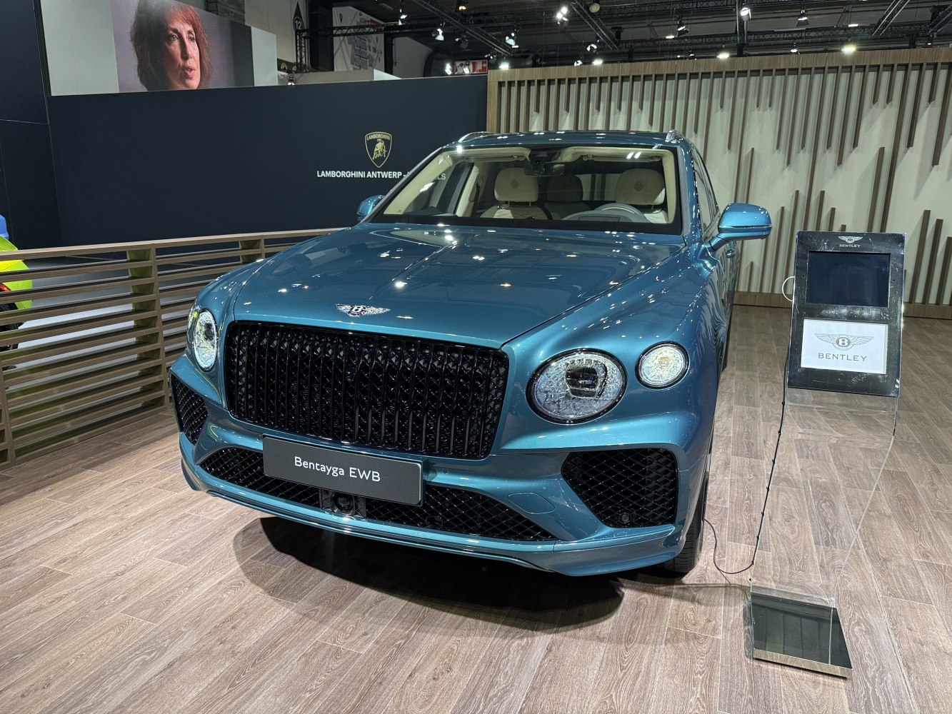 Blue luxury SUV front view with black mesh grille and round headlights