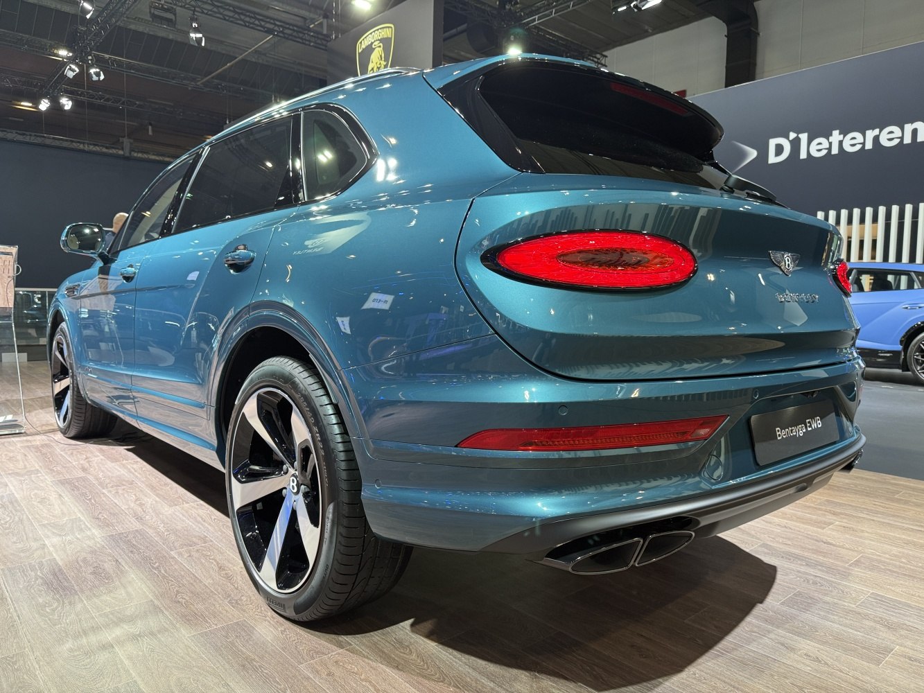 Rear and side view of luxury SUV with sleek taillights and large alloy wheels