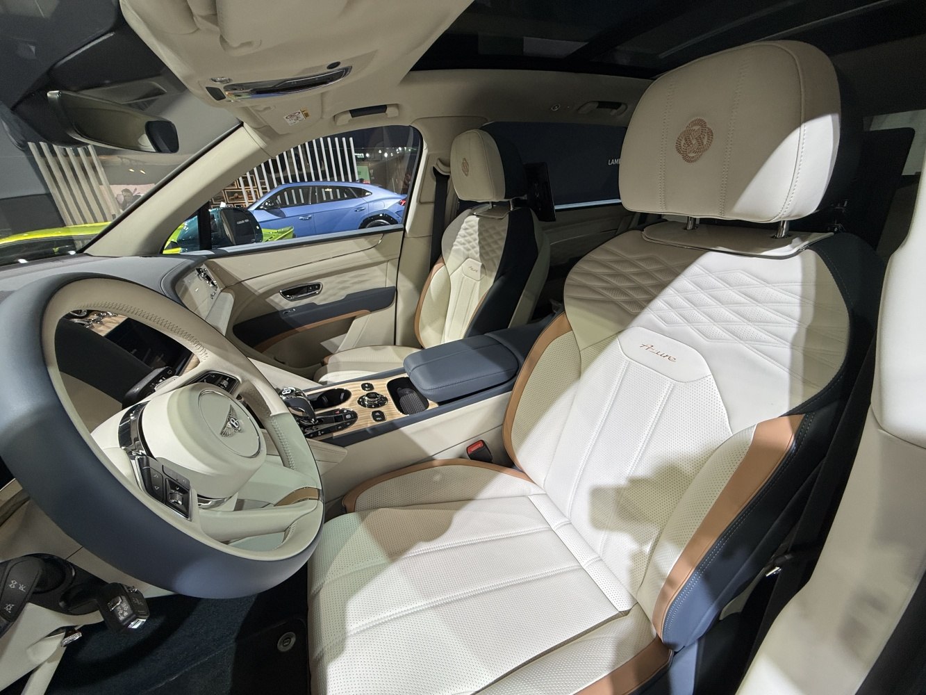 Luxury beige leather seats with quilted pattern and modern dashboard controls