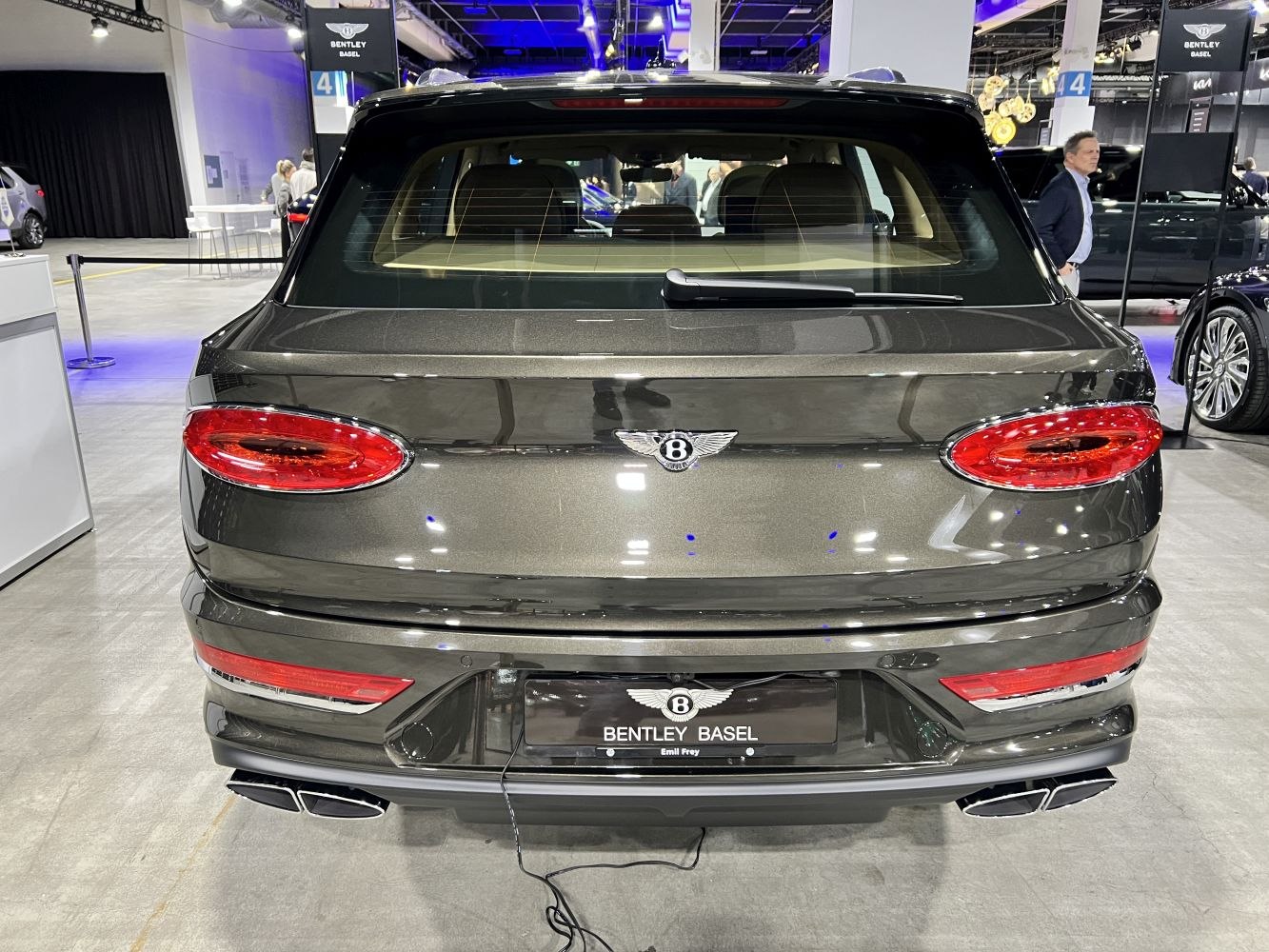Rear view of a luxury SUV with oval taillights and quad exhausts