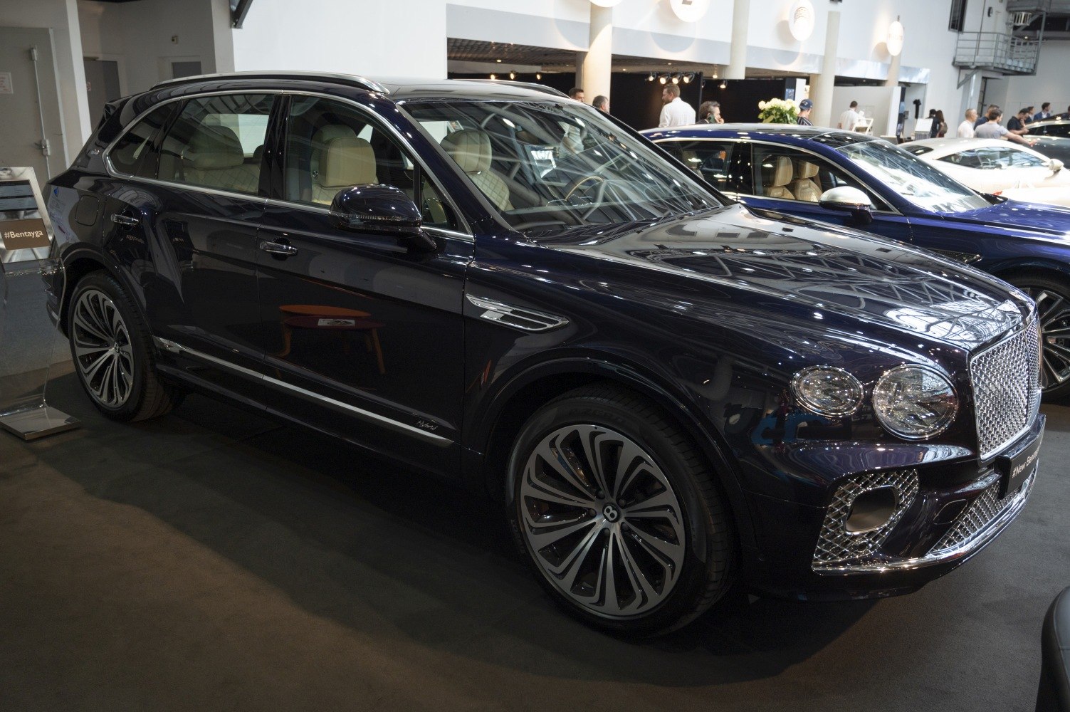 Luxury SUV front-side view with mesh grille and multi-spoke alloy wheels