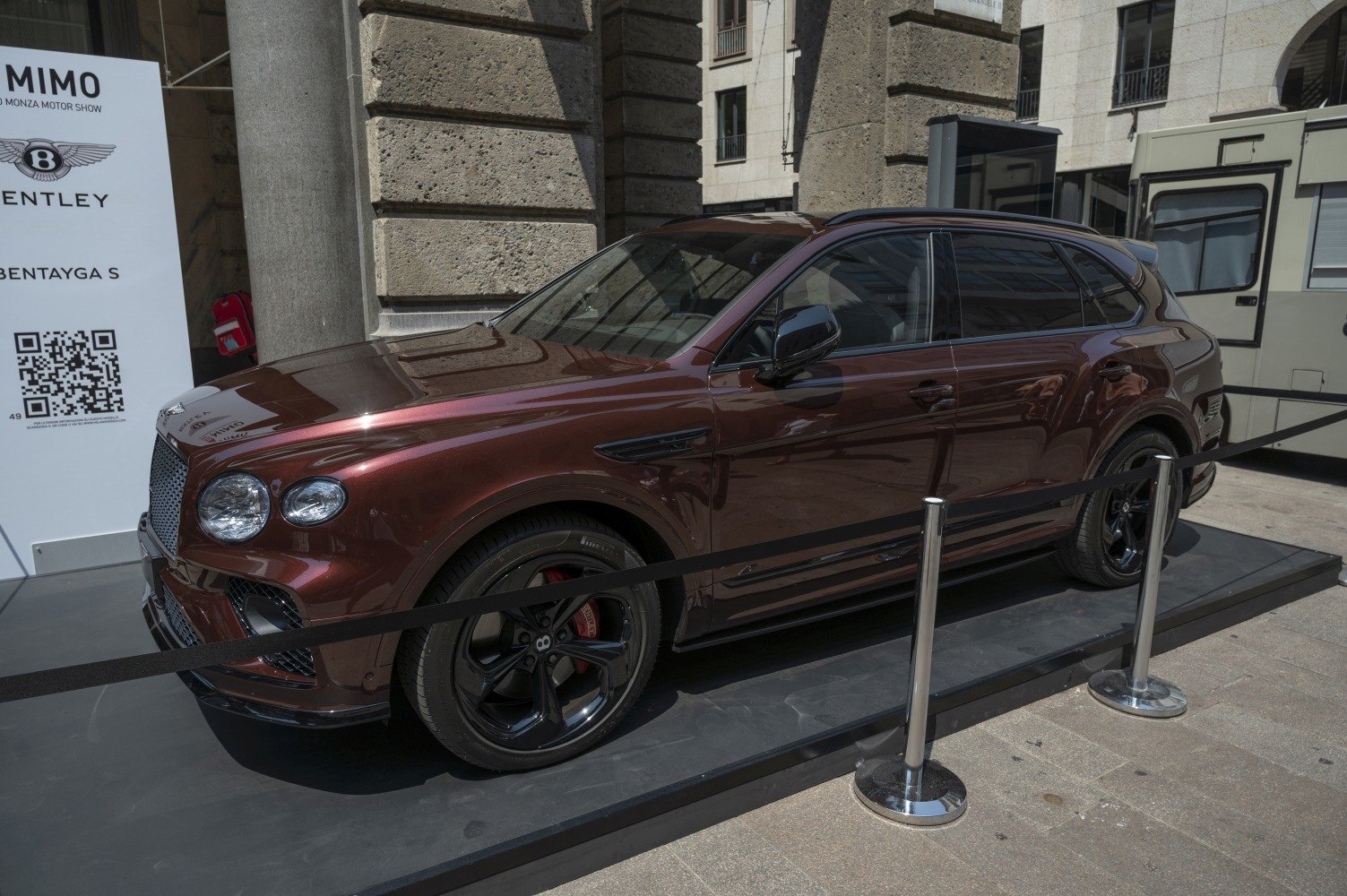 Luxury SUV front side view with black wheels in deep brown