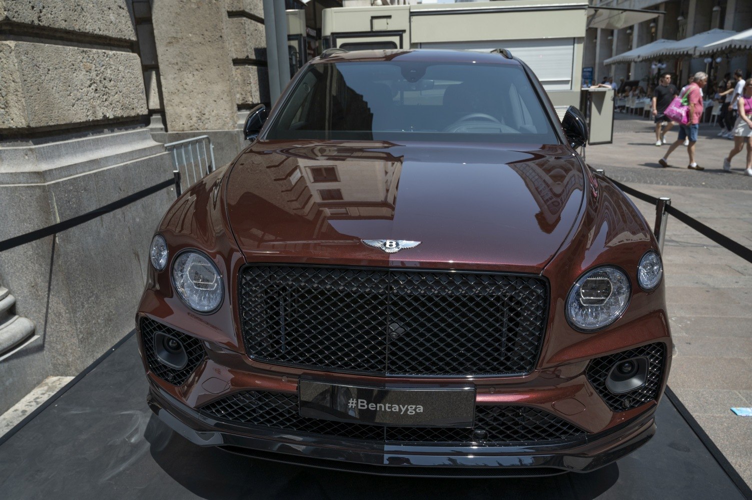 Front view with prominent black mesh grille and round headlights