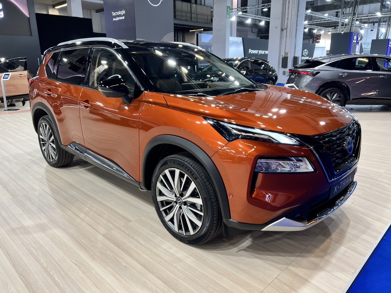 Orange SUV with LED headlights and distinctive front grille