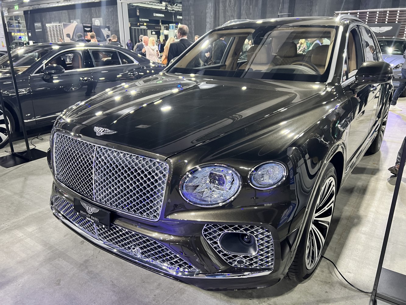 Diamond mesh grille with dual circular headlights and premium alloy wheels.