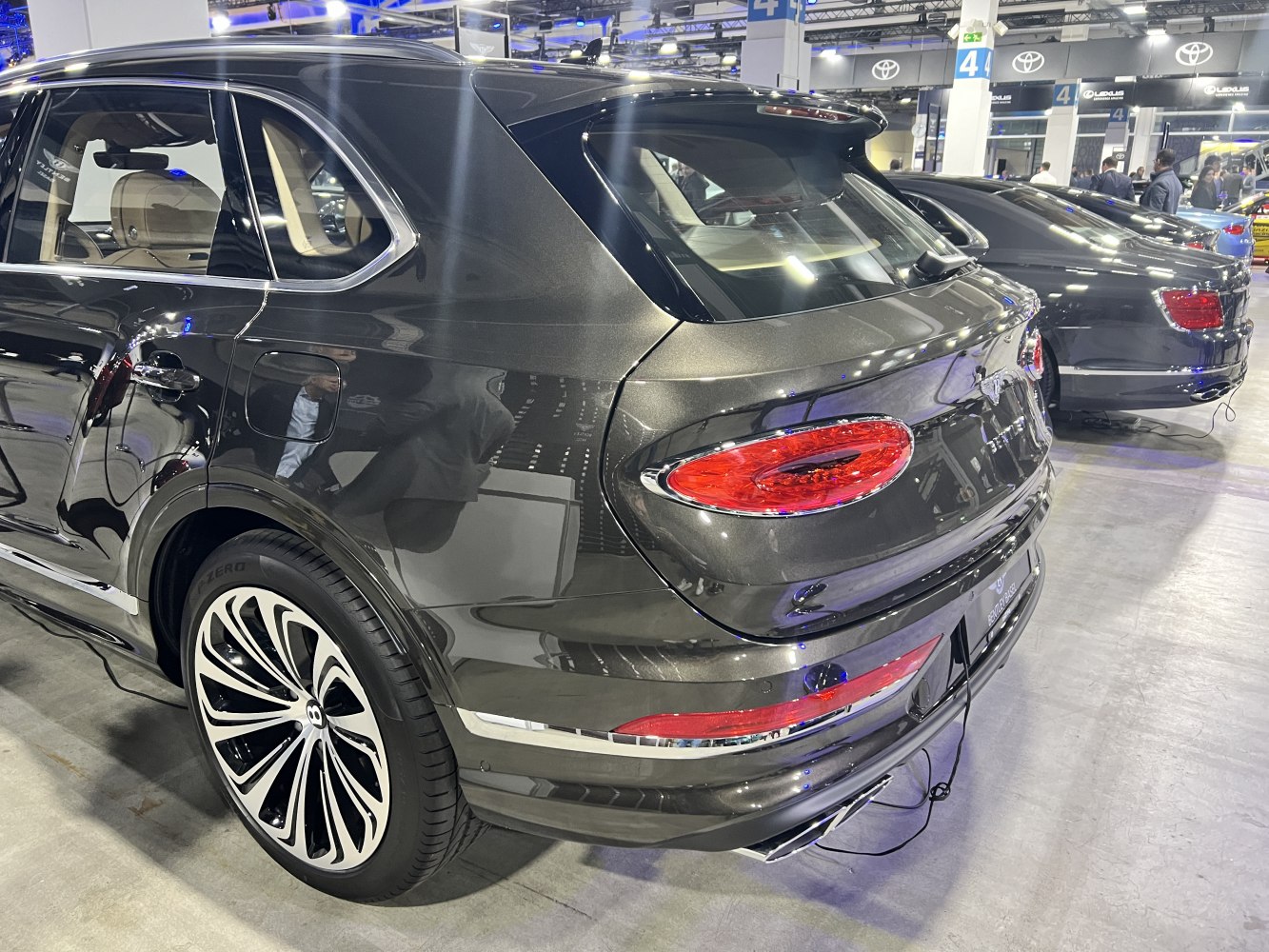 Rear view showing taillights, rear spoiler, and alloy wheels of a luxury SUV