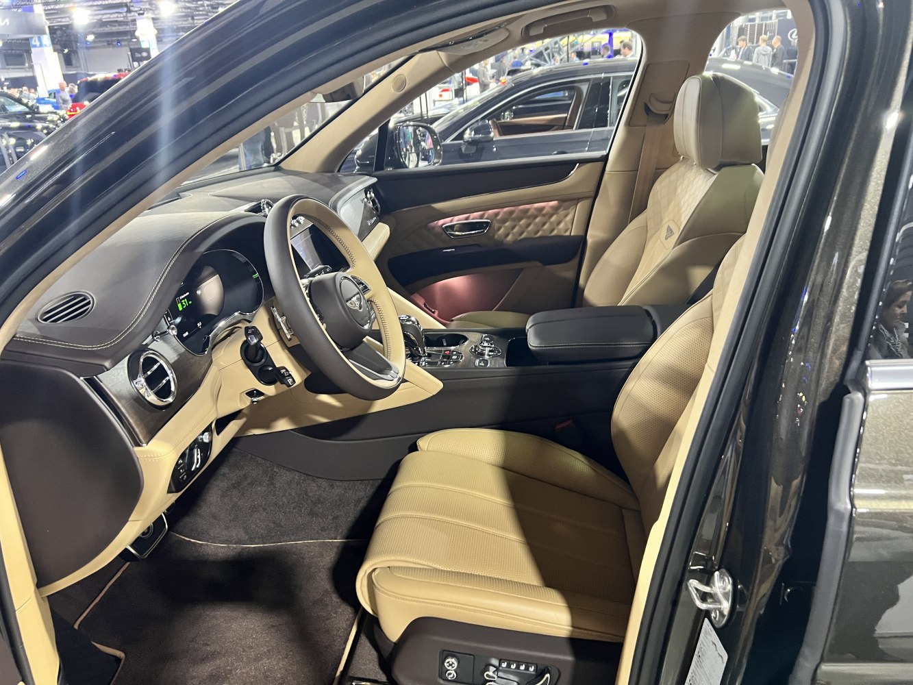 Beige leather seats with luxury quilted door panels and advanced dashboard.