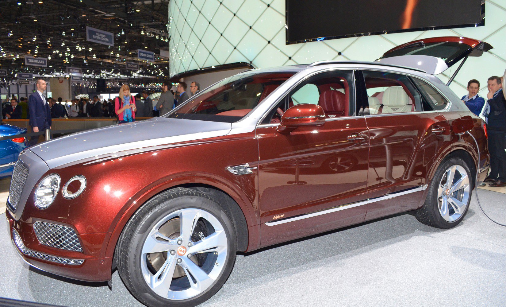 Two-tone luxury SUV with hybrid badge and visible plush interior