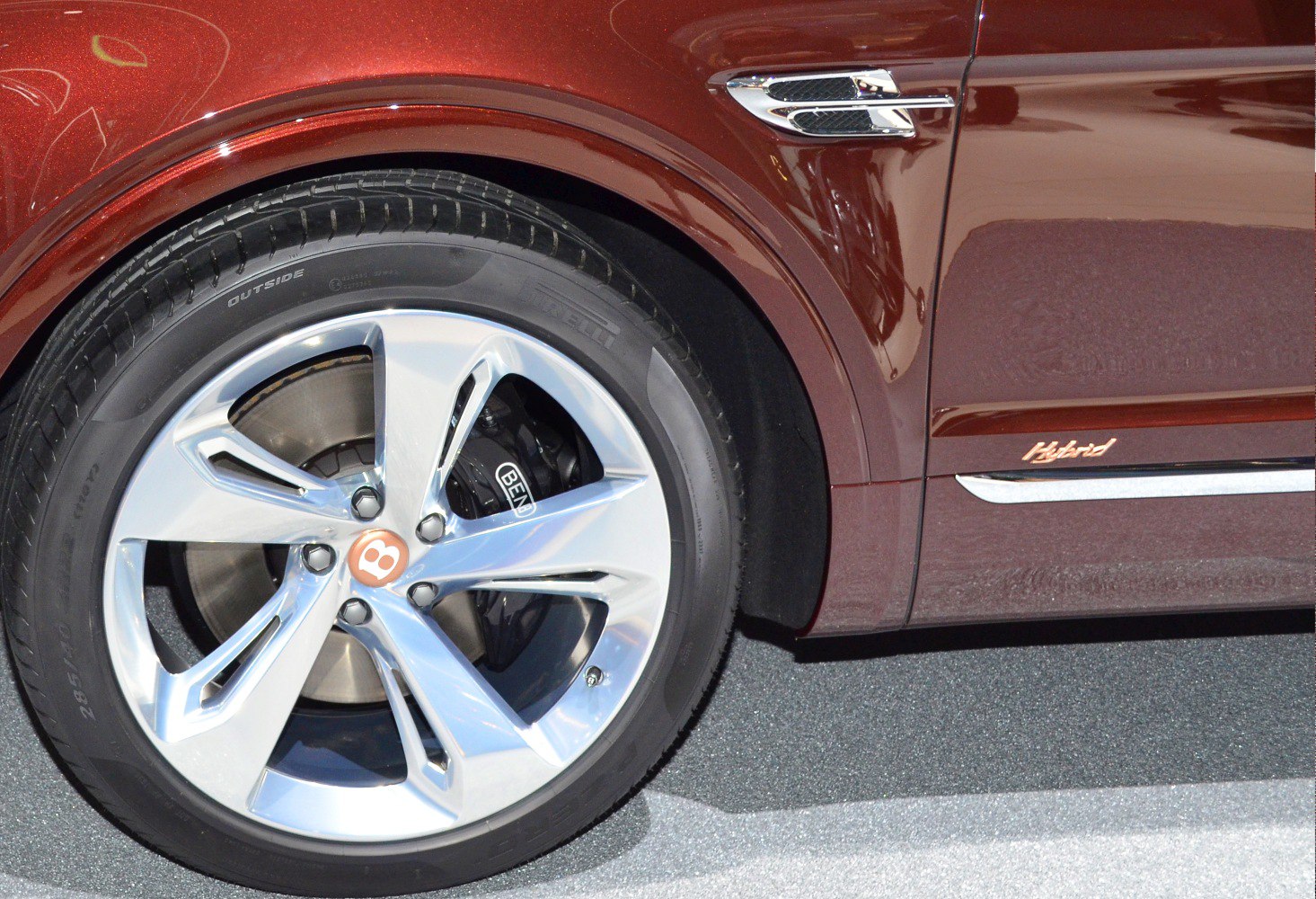 Alloy wheel, brake caliper, and hybrid badge on vehicle side