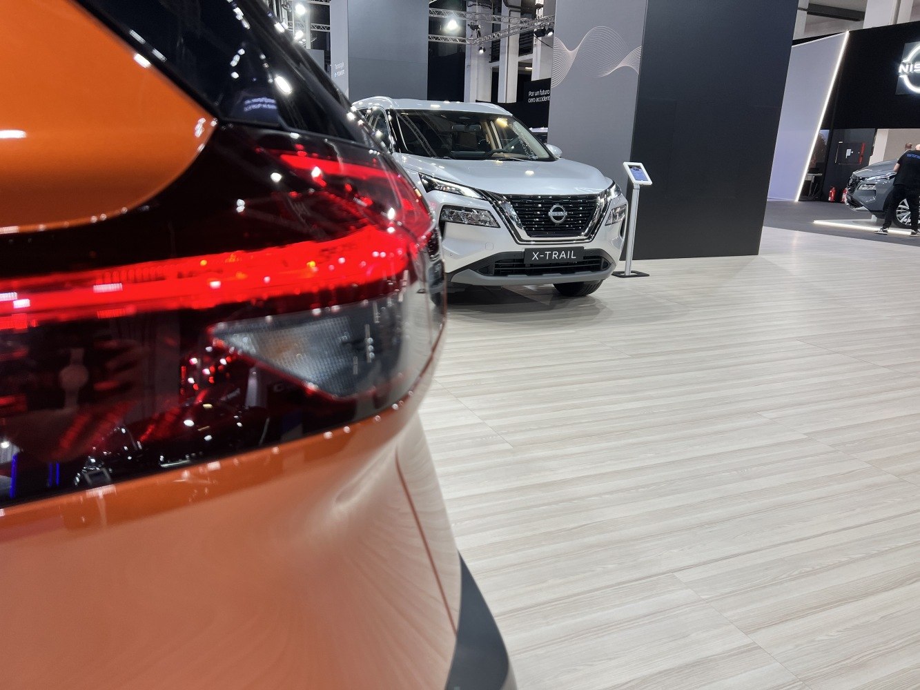 Close-up of rear light and frontal view of modern SUV indoors