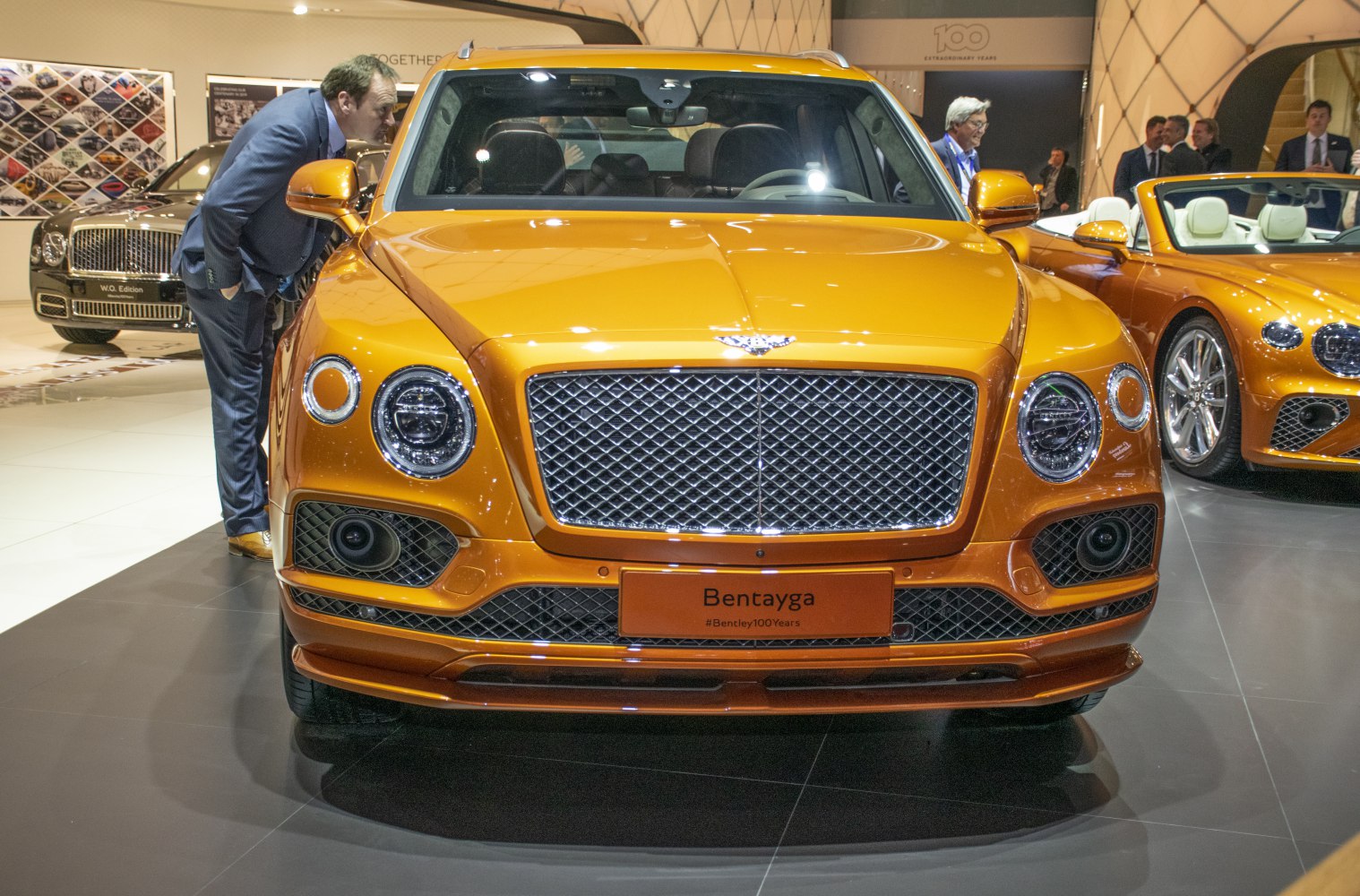 Luxury SUV front with large mesh grille and circular LED headlights