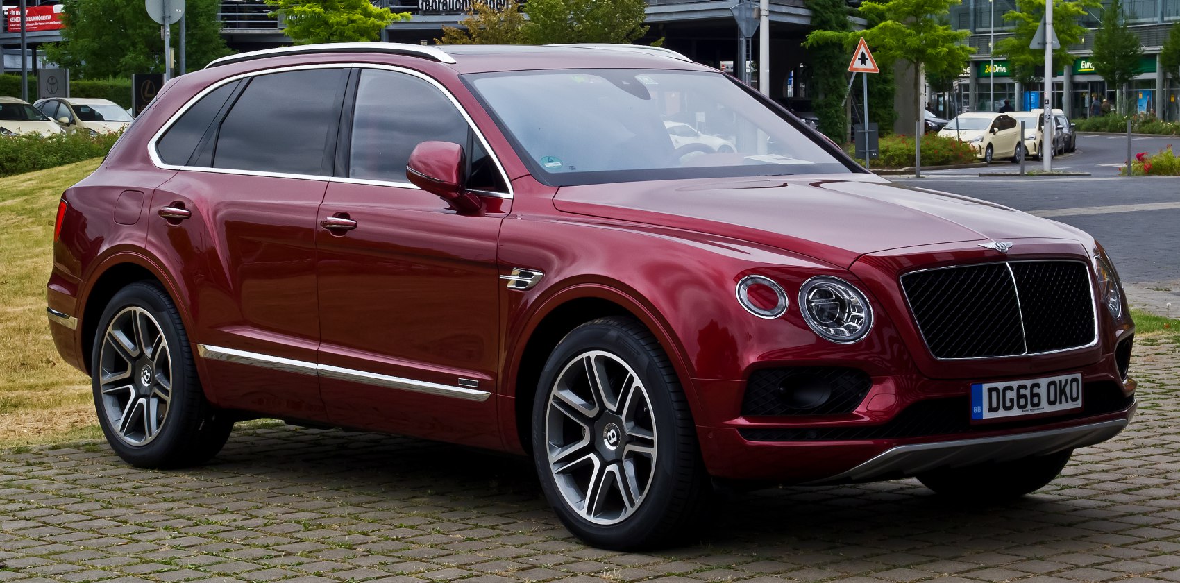 Red luxury SUV with round headlights and chrome trim