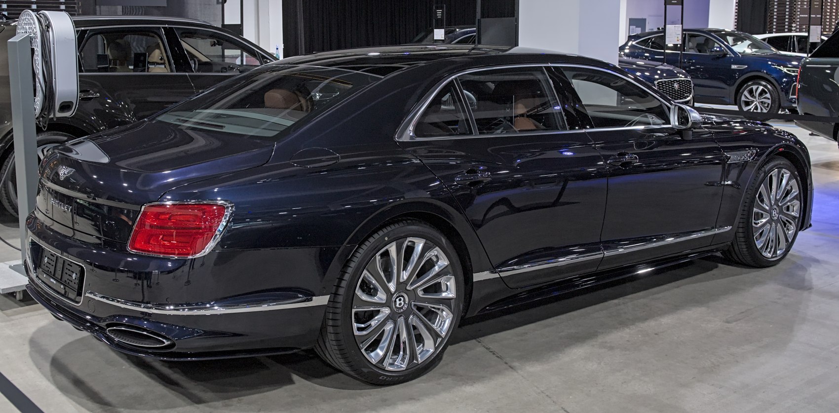Luxury sedan rear and side profile with premium wheels and sleek design