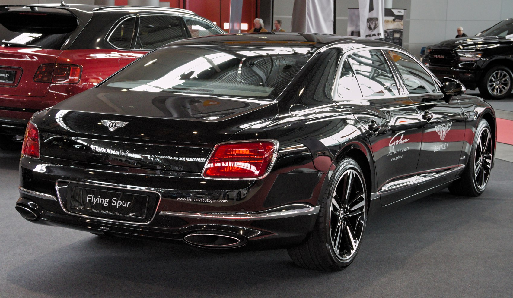 Rear view of a luxury sedan with distinct tail lights and alloy wheels