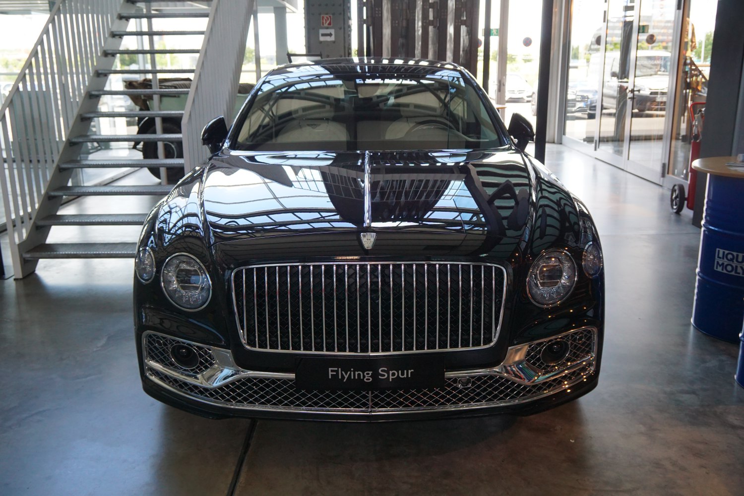 Luxury sedan front view with distinctive grille and round headlights