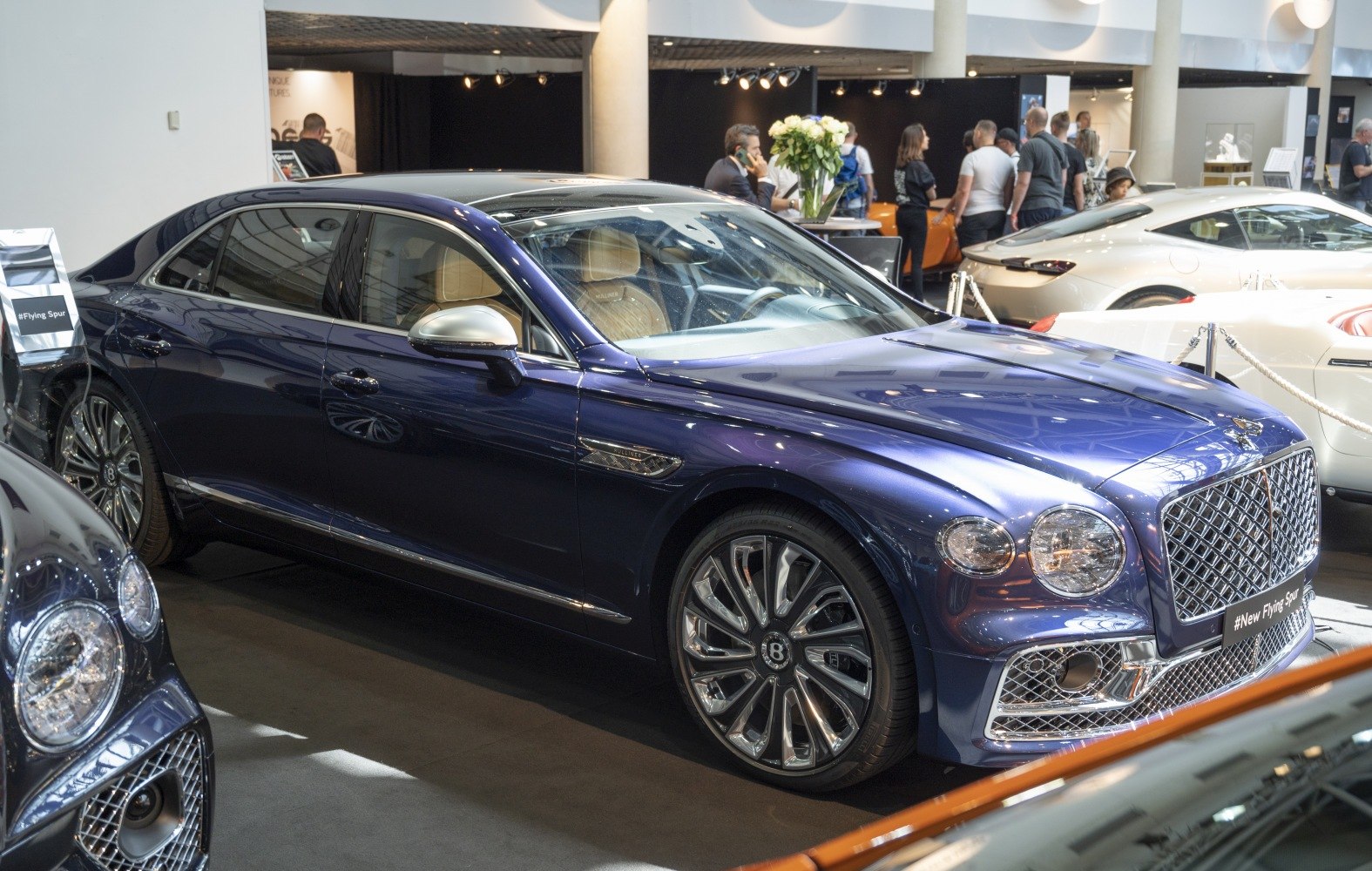 Luxury sedan front side view with intricate grille and alloy wheels