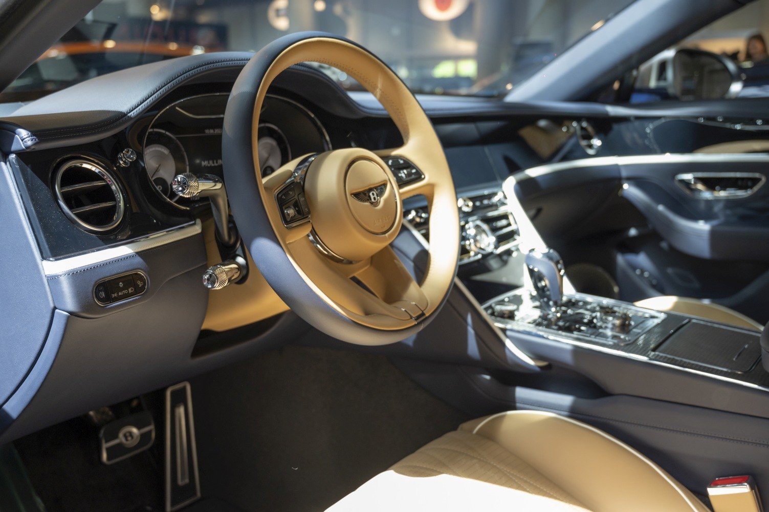 Luxury beige leather steering wheel and dashboard with instrument cluster