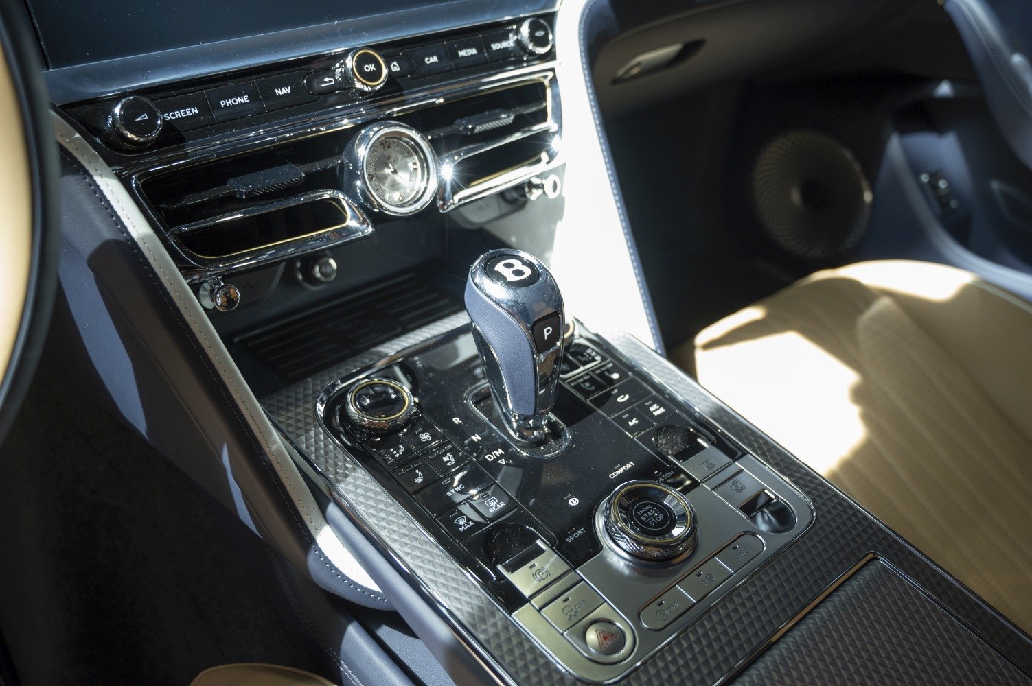 Luxury gear shifter and control panel with analog clock and infotainment buttons
