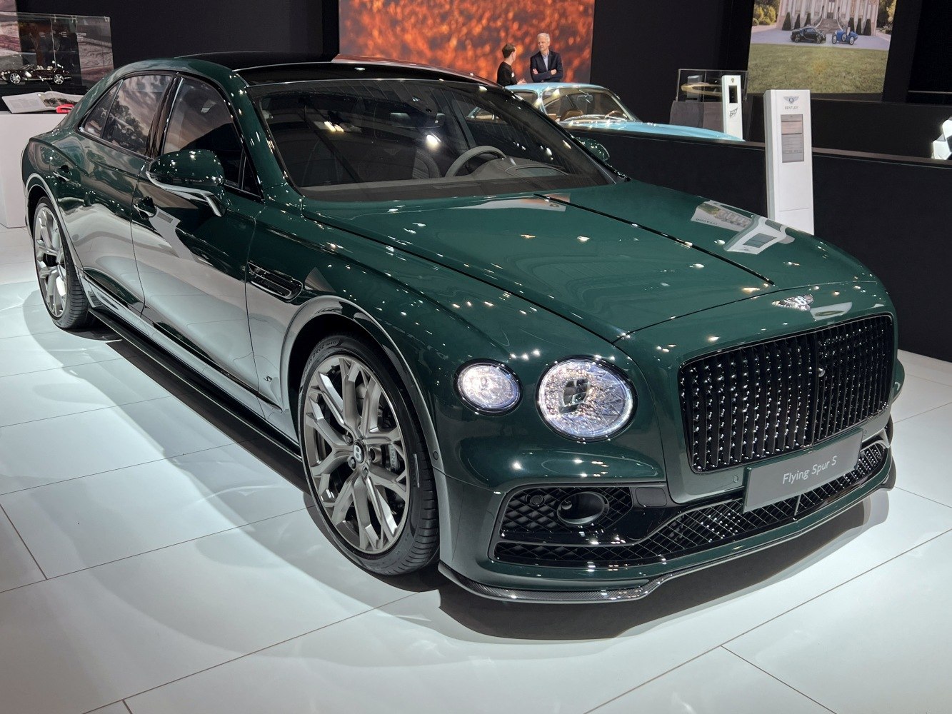 Front-angle view of a luxury sedan with signature round headlights and bold grille