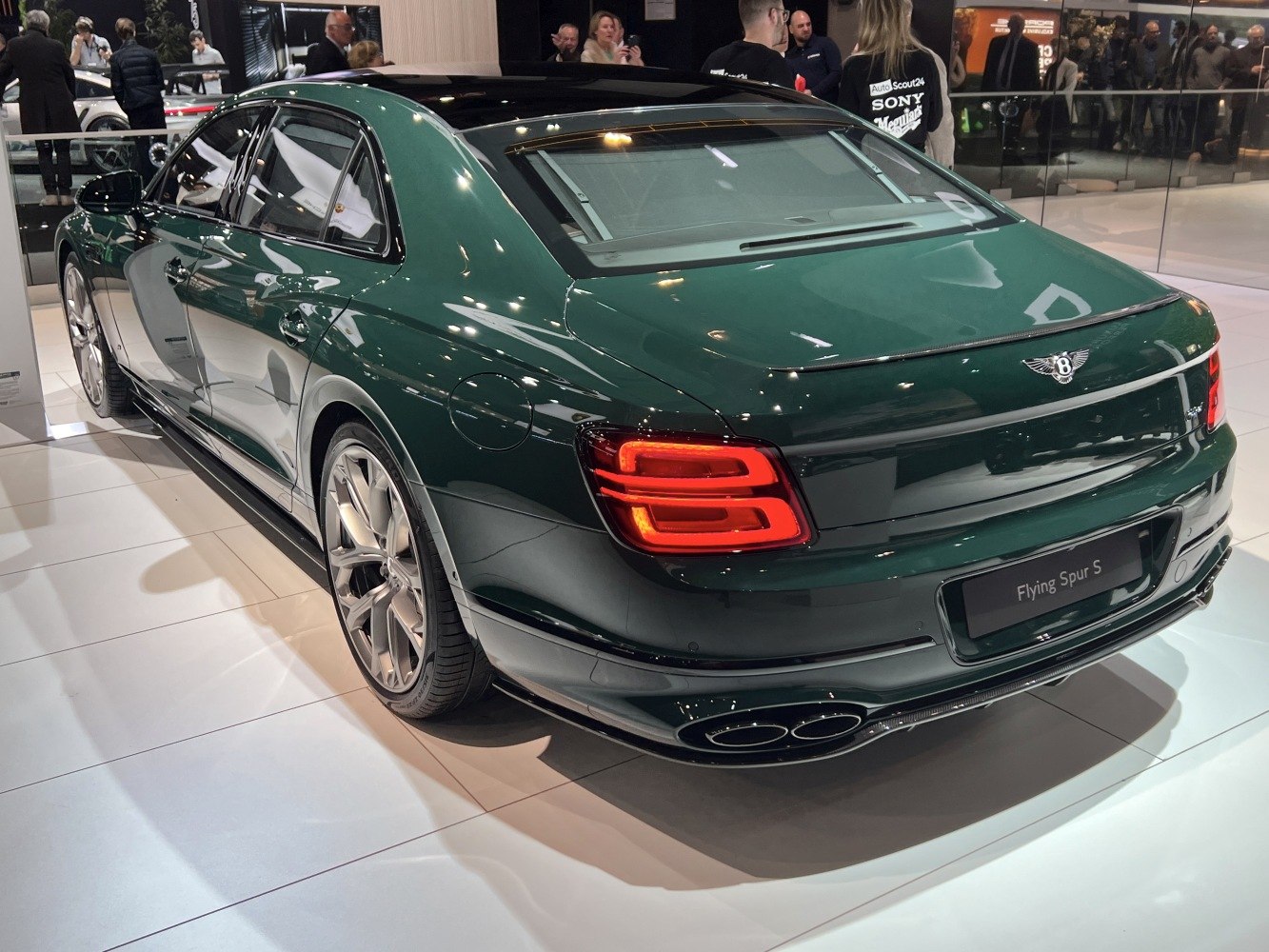 Rear view of luxury sedan with distinctive taillights and quad exhaust pipes