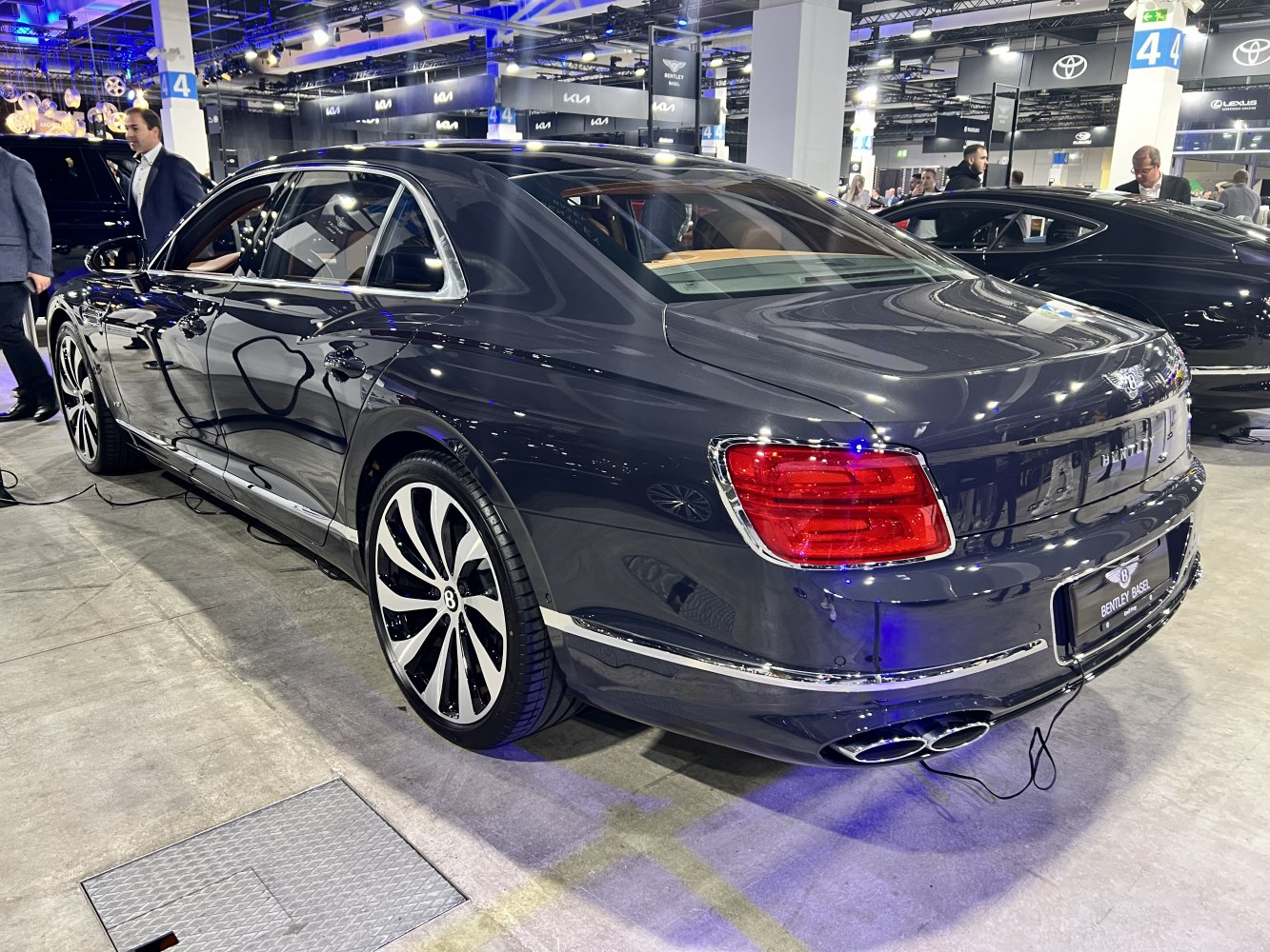 Luxury sedan rear side with distinctive tail lights and elegant alloy wheels
