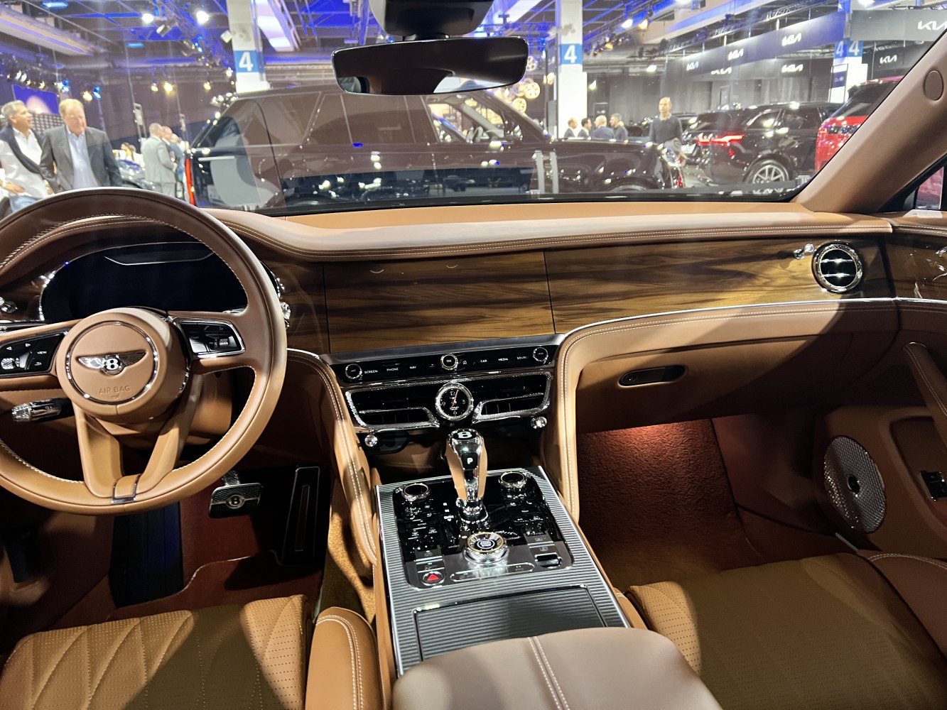 Luxury brown leather interior with wood grain dashboard and advanced console controls