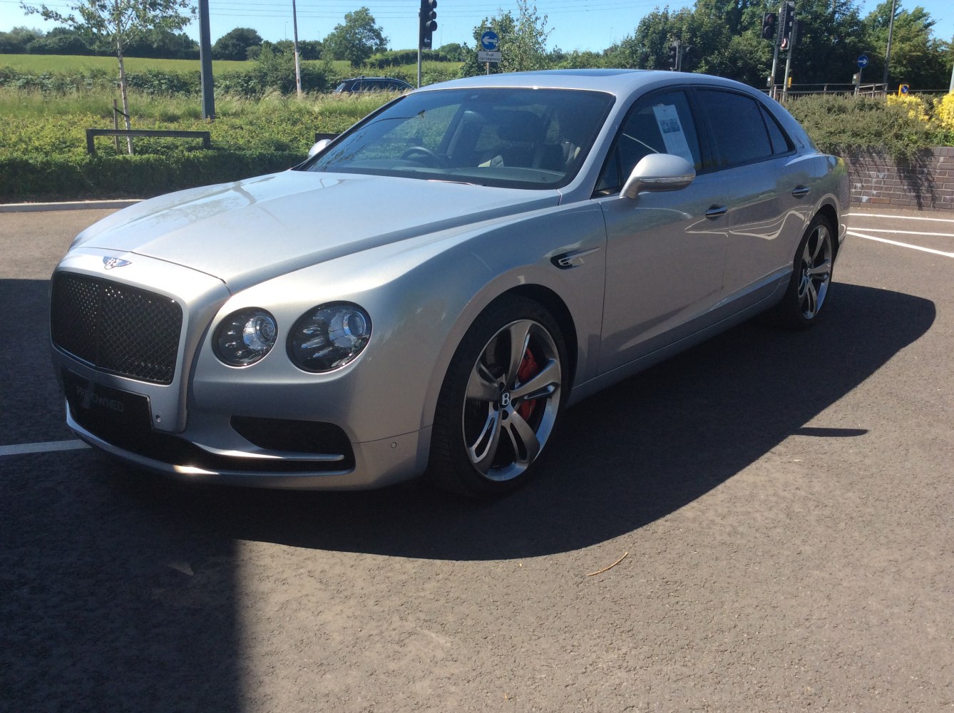 Luxury sedan front side view with alloy wheels