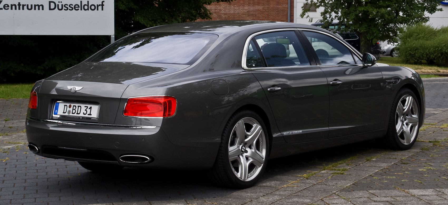 Rear view of a luxury sedan with oval exhaust and sleek taillights