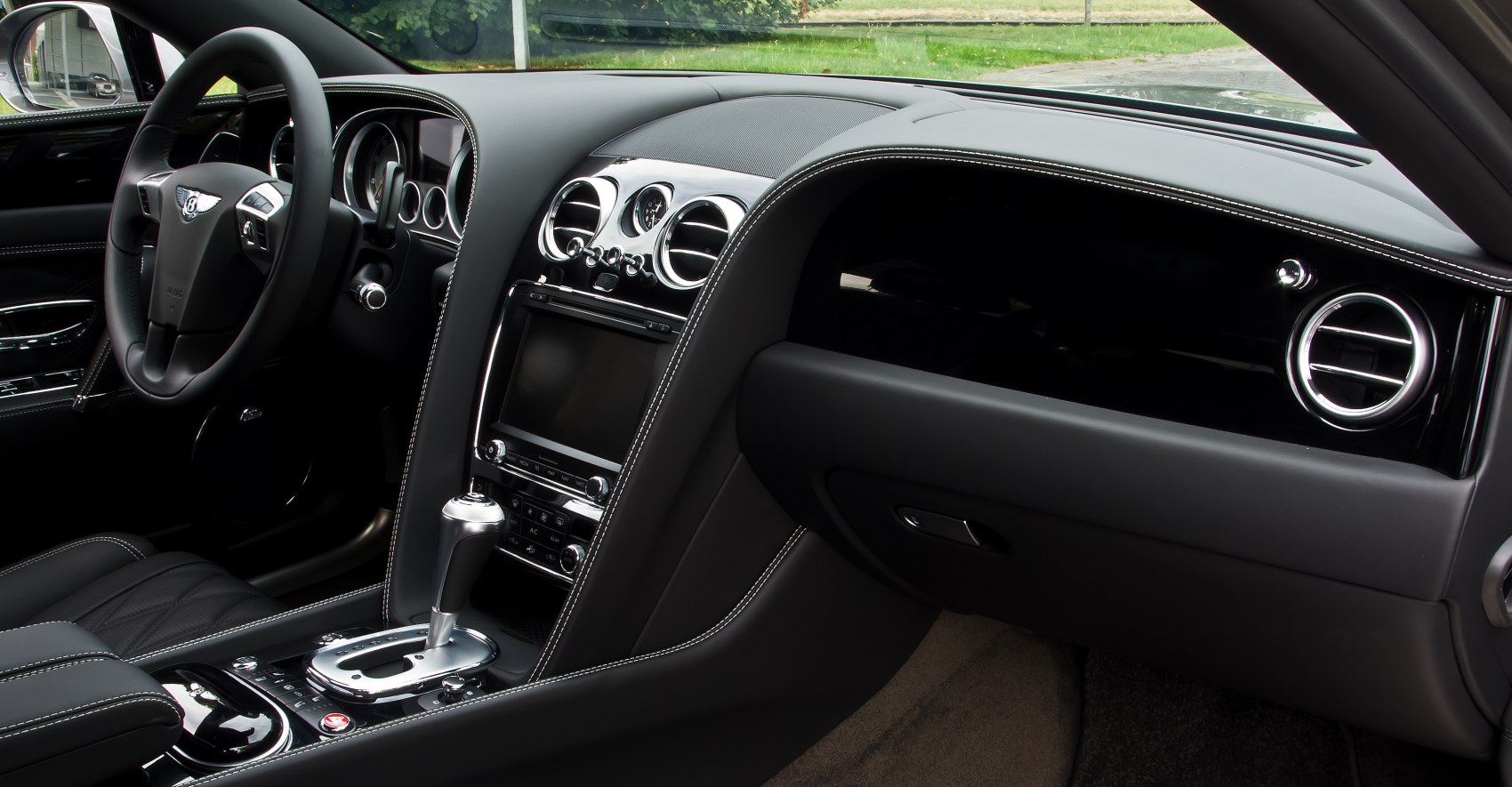 Black leather interior with dashboard, center console, and gear shift lever