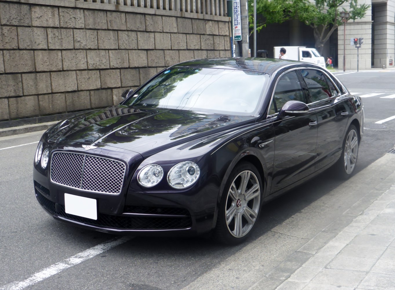 Luxury sedan with mesh grille and quad circular headlights