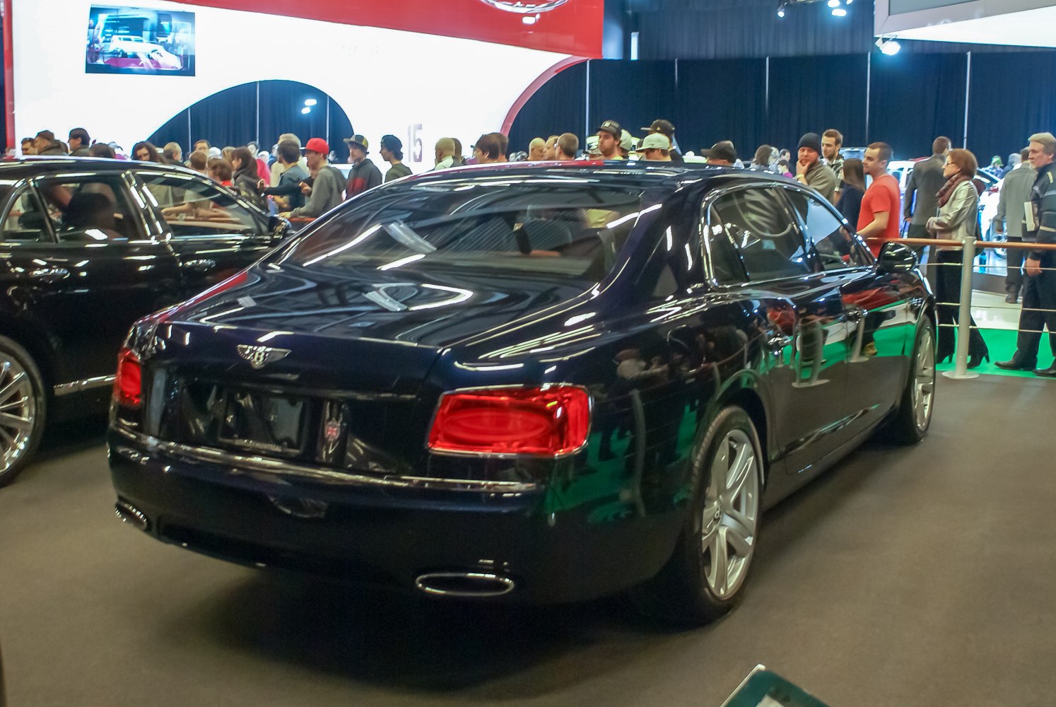 Rear view of luxury sedan with distinctive taillights and twin exhausts