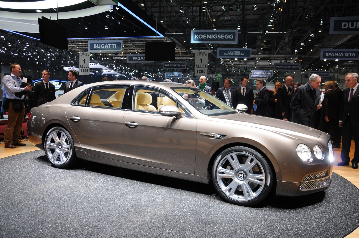 Luxury sedan with large alloy wheels at auto exhibition