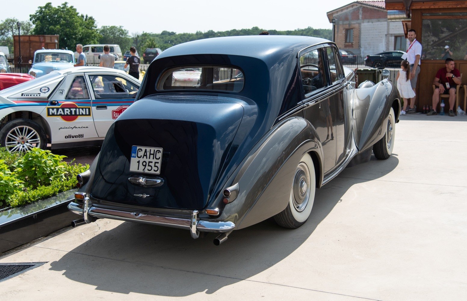 Vintage luxury sedan rear with curved fenders and whitewall tires