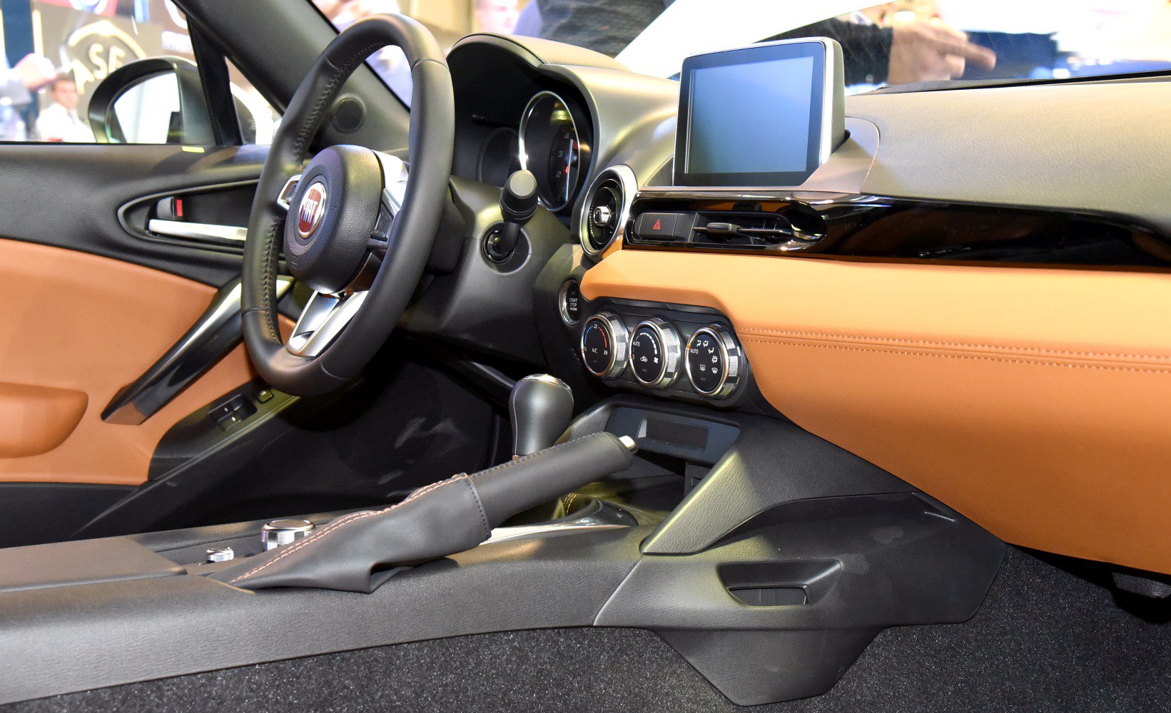 Dashboard, steering wheel, center console with infotainment screen and climate controls.