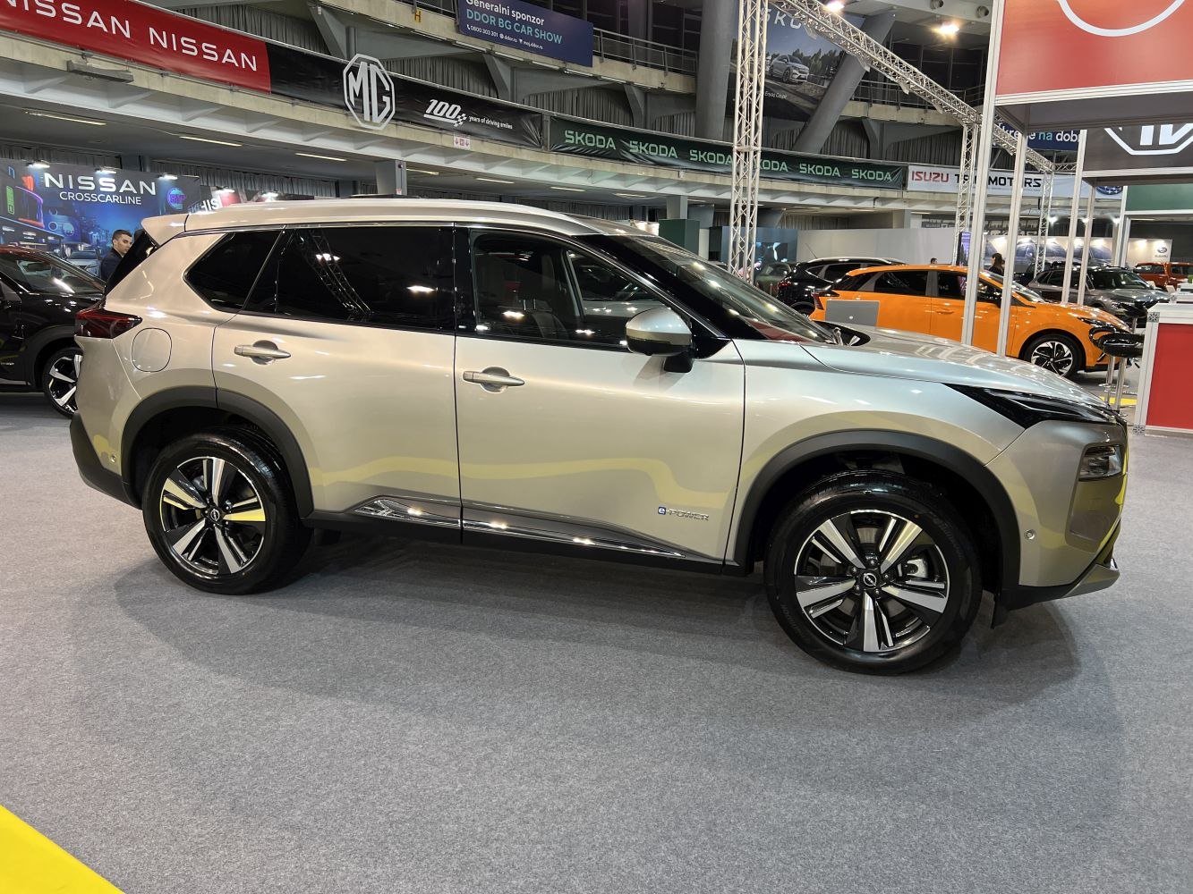 Side view of silver SUV with alloy wheels and aerodynamic body shape