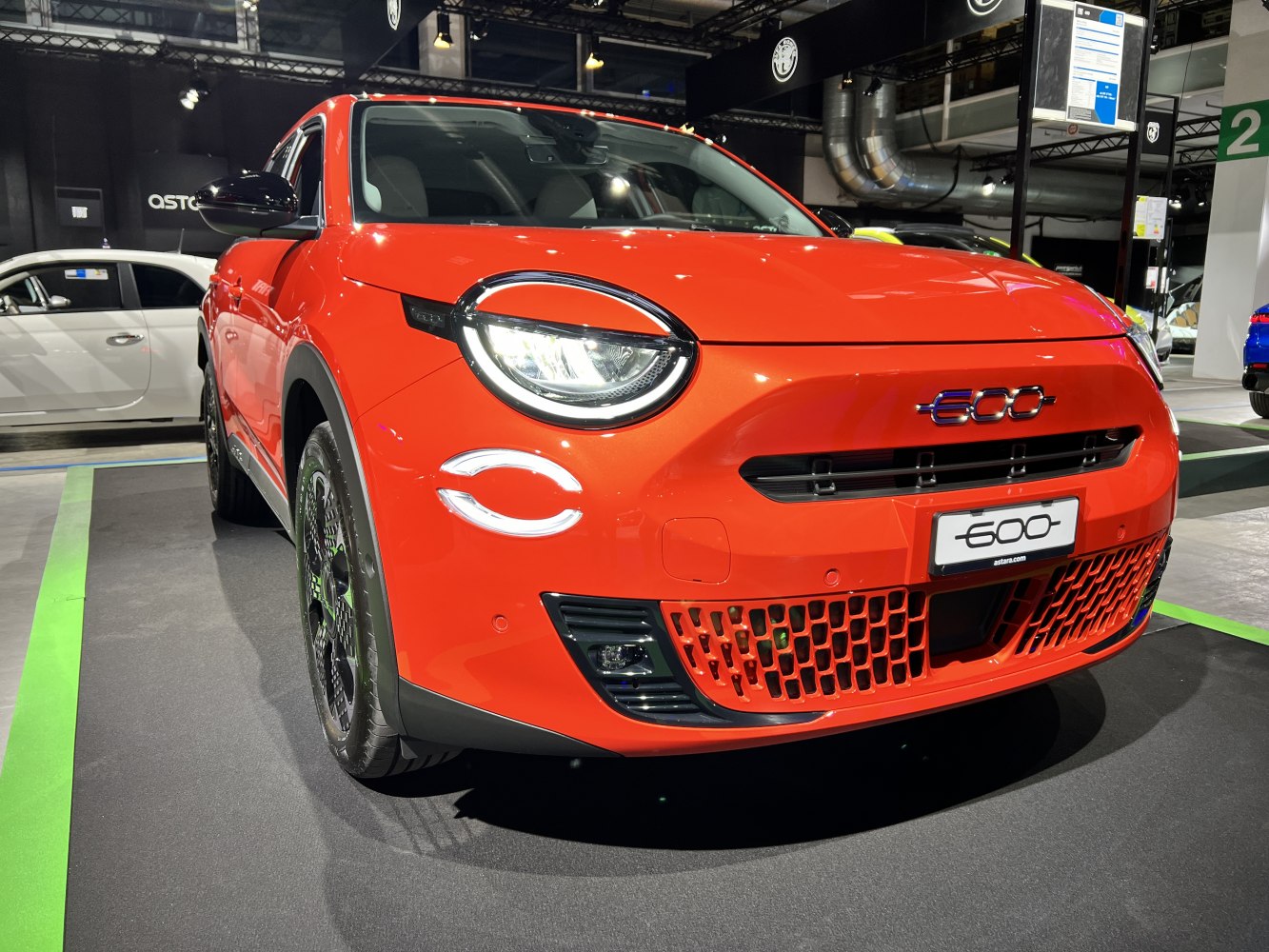 Round LED headlights and unique modern front grille in vibrant red
