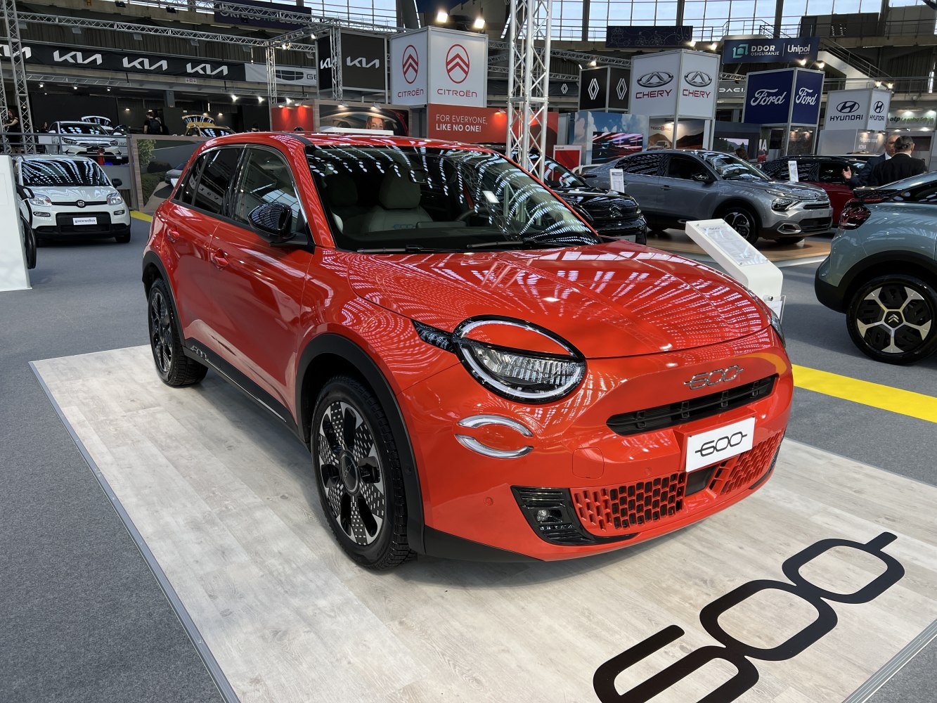 Round LED headlights and sporty alloy wheels on a red compact hatchback