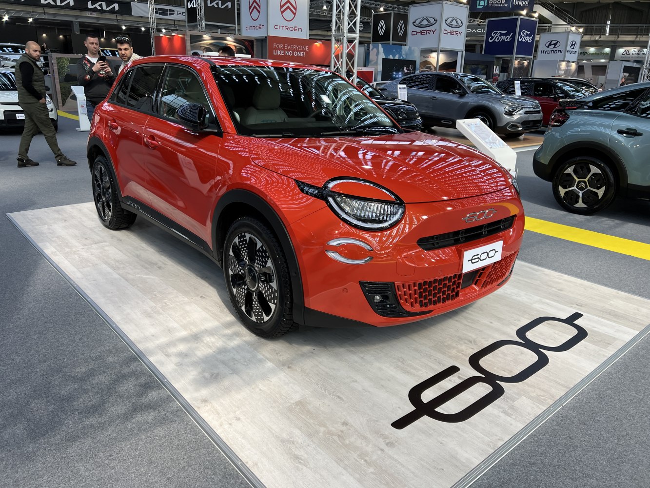 Electric compact SUV with round LED headlights and modern front grille design