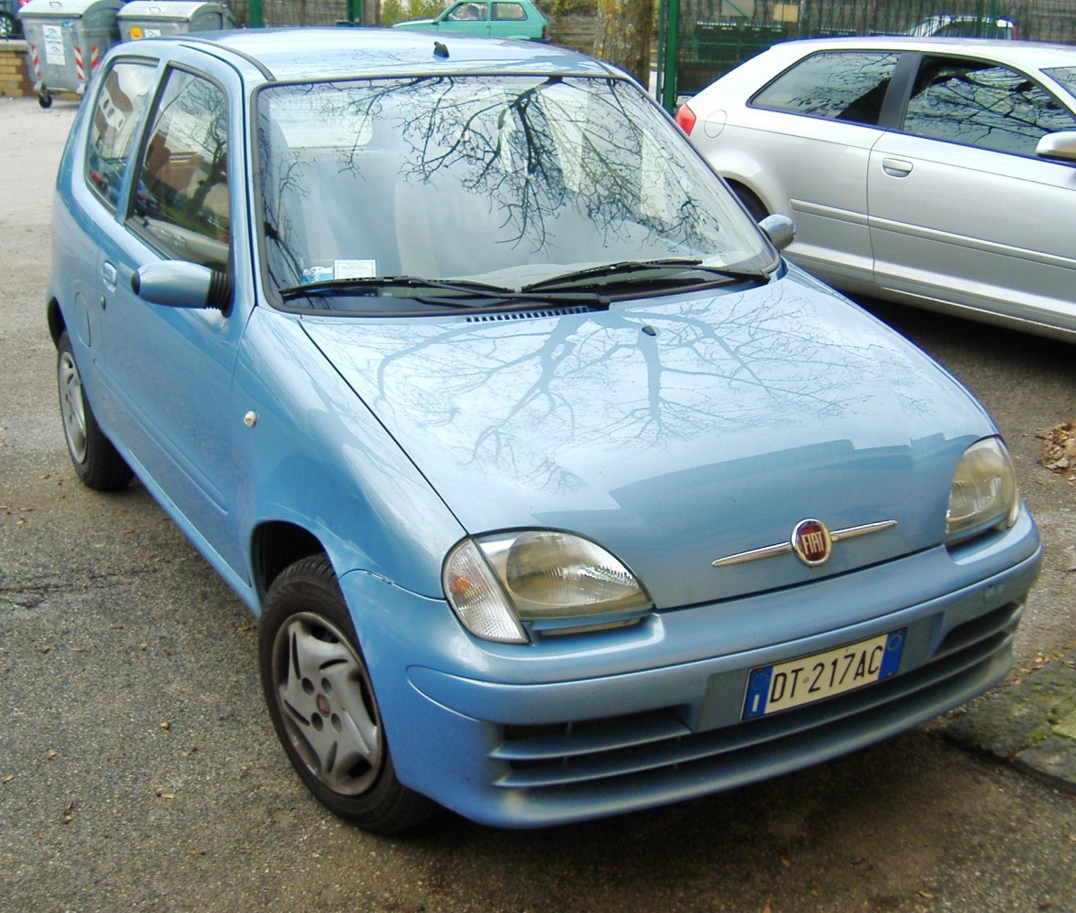 Compact blue hatchback with distinctive headlights and aerodynamic front design