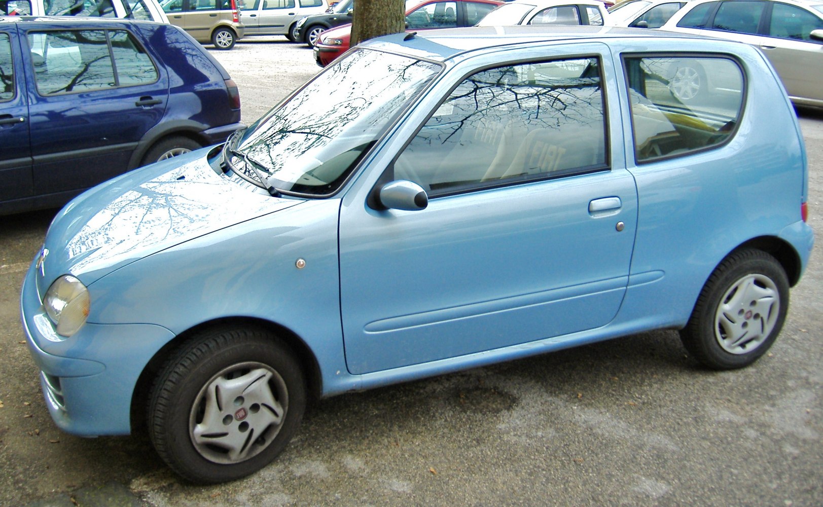 Compact two-door hatchback with rounded headlights and smooth body shape